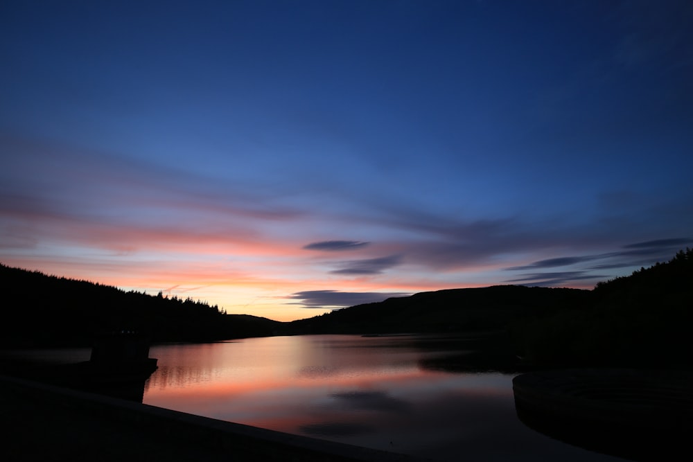 silhouette of mountain and lake