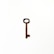 A rusty, old-fashioned key is placed against a plain white background. The key has an elongated shaft with a rectangular bow and a single toothed bit.