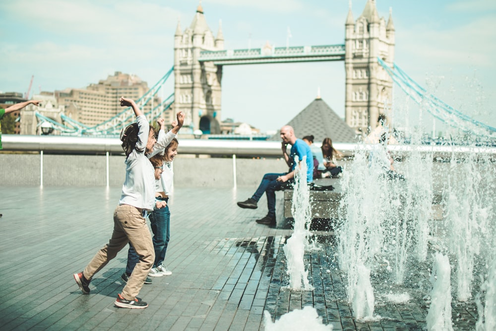 children playing near fountain