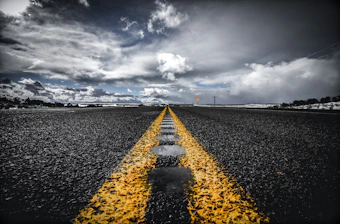 Close-up of freshly laid asphalt road under bright sunlight