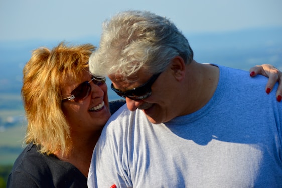 A warm, inviting photo of a smiling senior couple enjoying a peaceful moment outdoors.