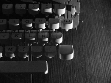 A close-up of a vintage typewriter with glowing circuit board patterns blending into the keys.