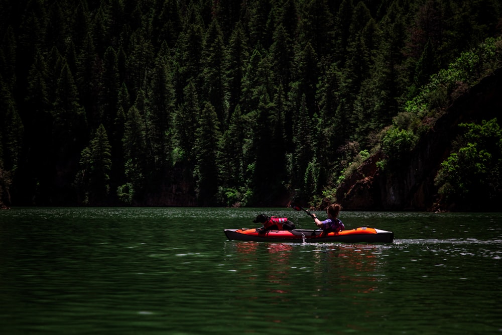 person riding kayak on body of water