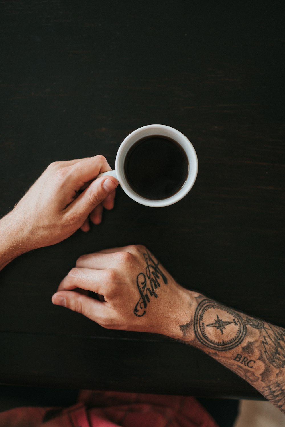 person holding white mug