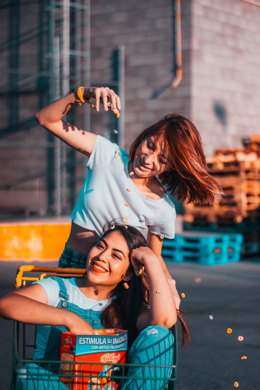 two women riding push cart