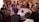 A group of diverse people engaged in a thoughtful discussion around a table.