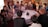 A group of diverse people engaged in a thoughtful discussion around a table.