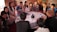 A diverse group of people engaged in a community discussion around a table.