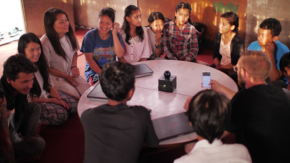 people sitting on floor front of table