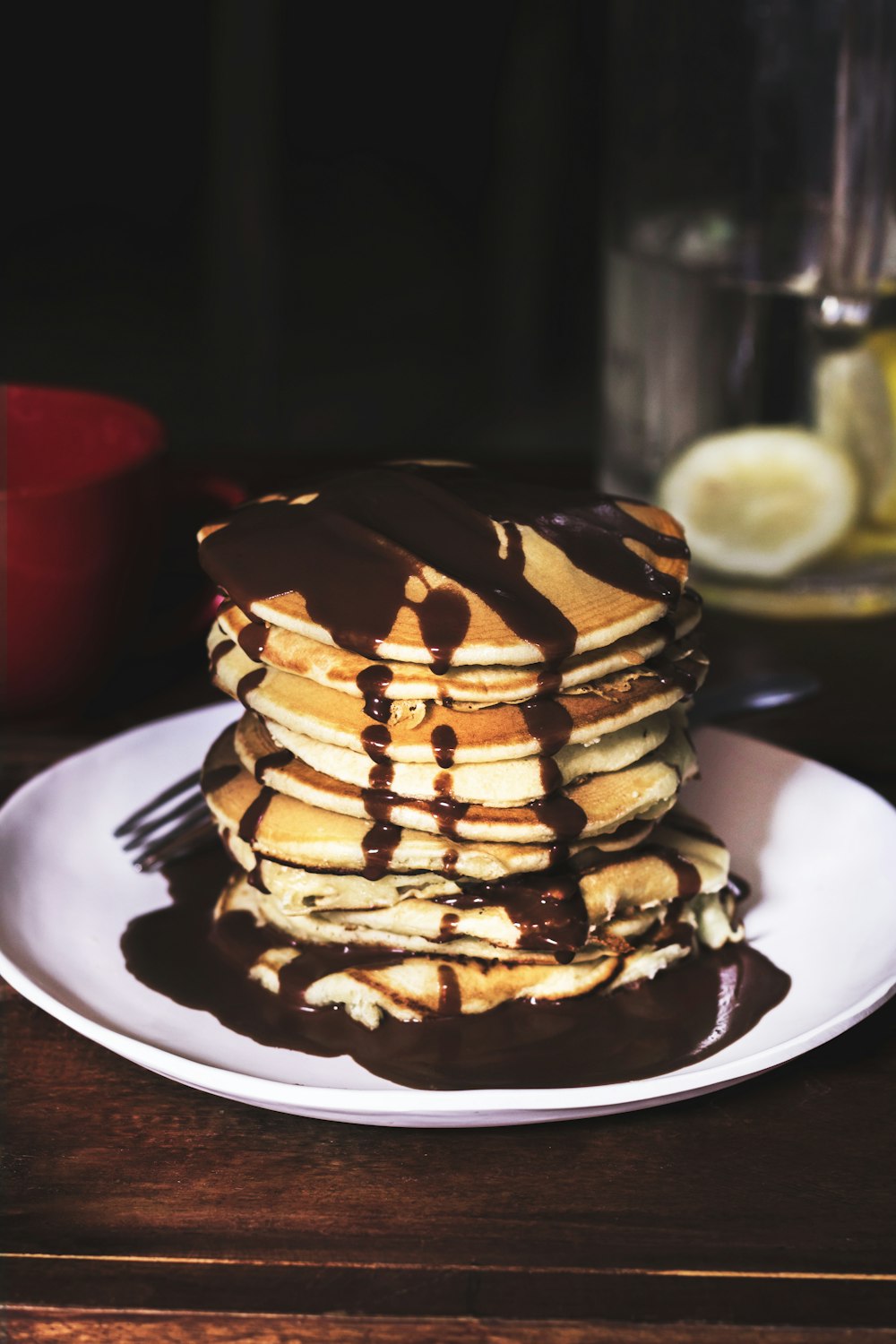 pancake on round plate with chocolate syrup