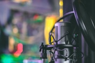 gray condenser microphone with pop filter in closeup photography