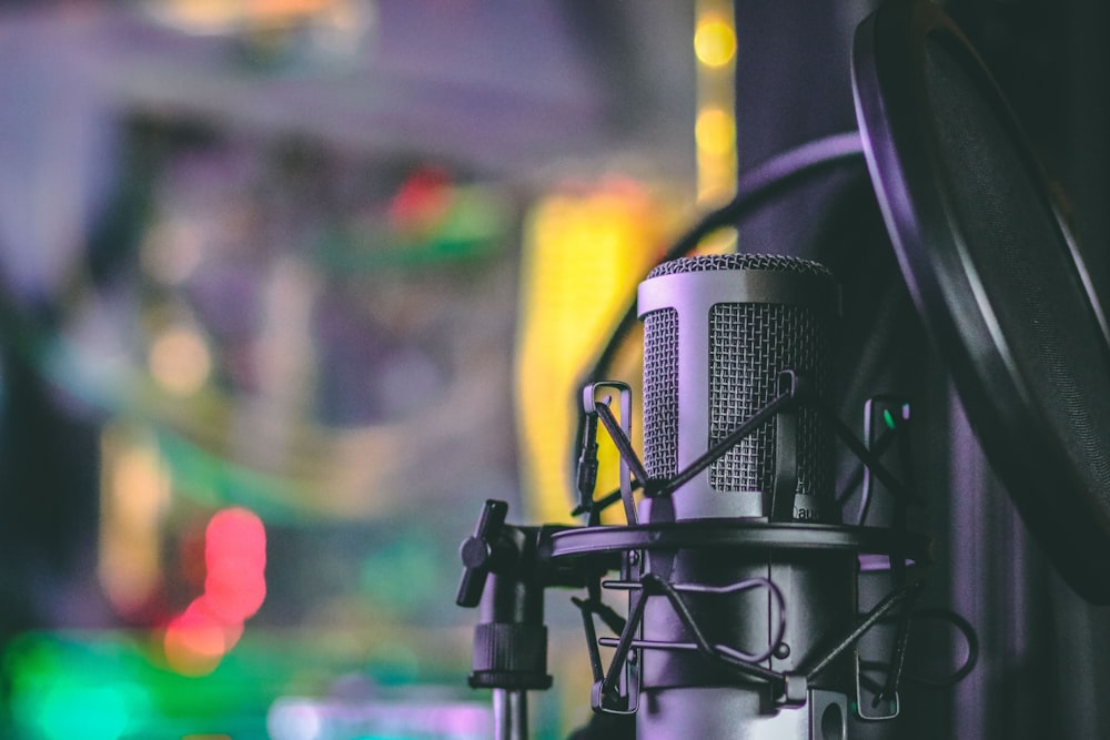 gray condenser microphone with pop filter in closeup photography