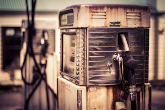 Close-up of a weathered, rusted gas pump detail showing aged patina before restoration.