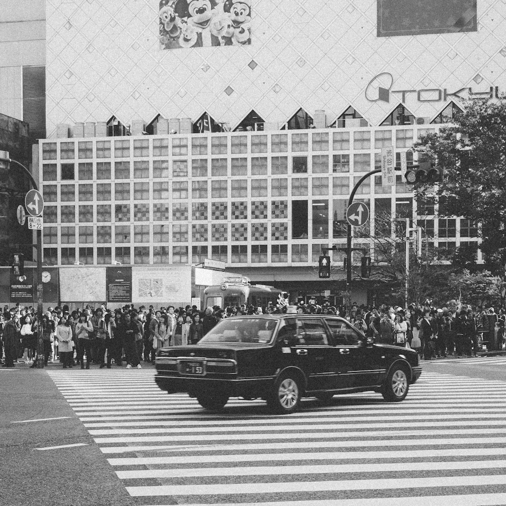 greyscale photo of car on the road