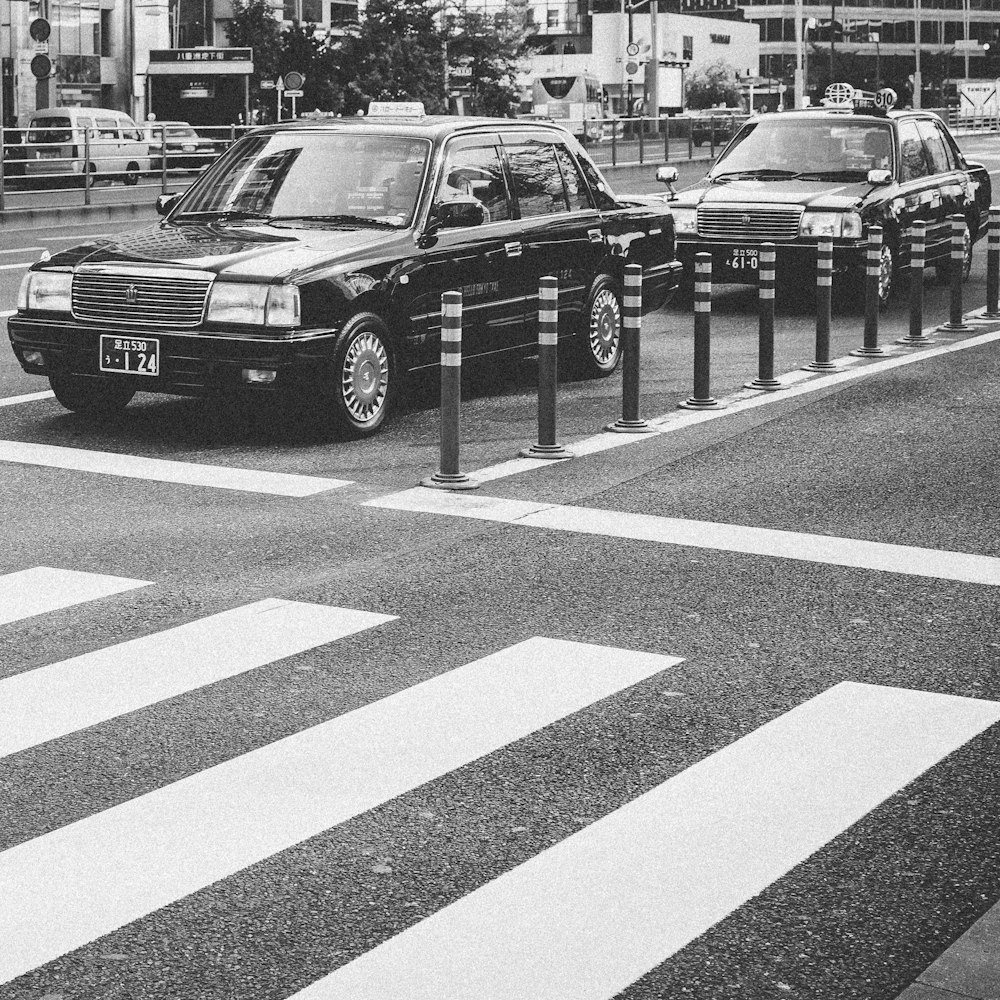 two sedan parked on asphalt road