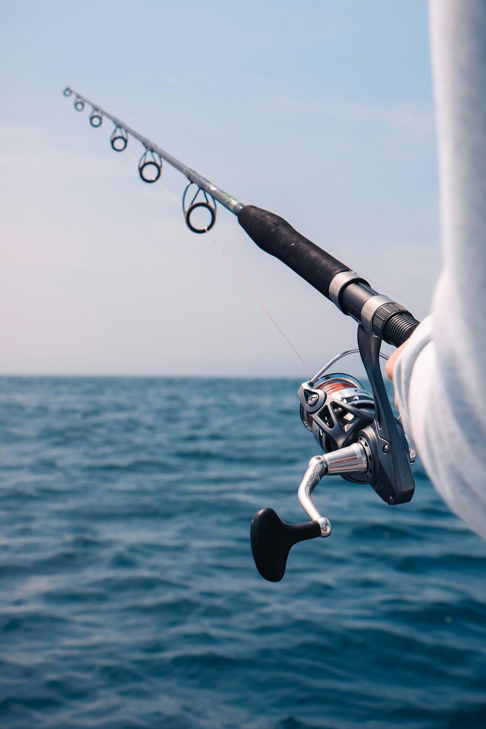 person holding black fishing rod