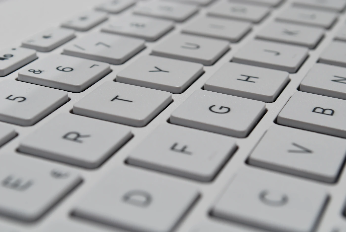 A close-up of hands typing on a keyboard, ghost text appearing at the cursor