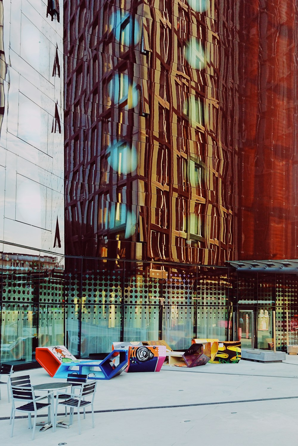 round white table and chairs in front of high-rise buildings