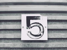 gray tile with white number five printed text
