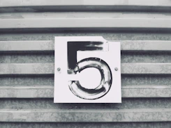 gray tile with white number five printed text