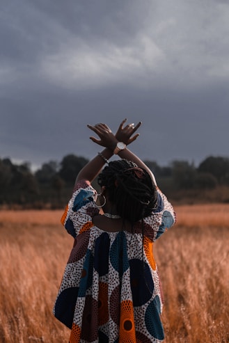 woman standing in the middle of wheat field