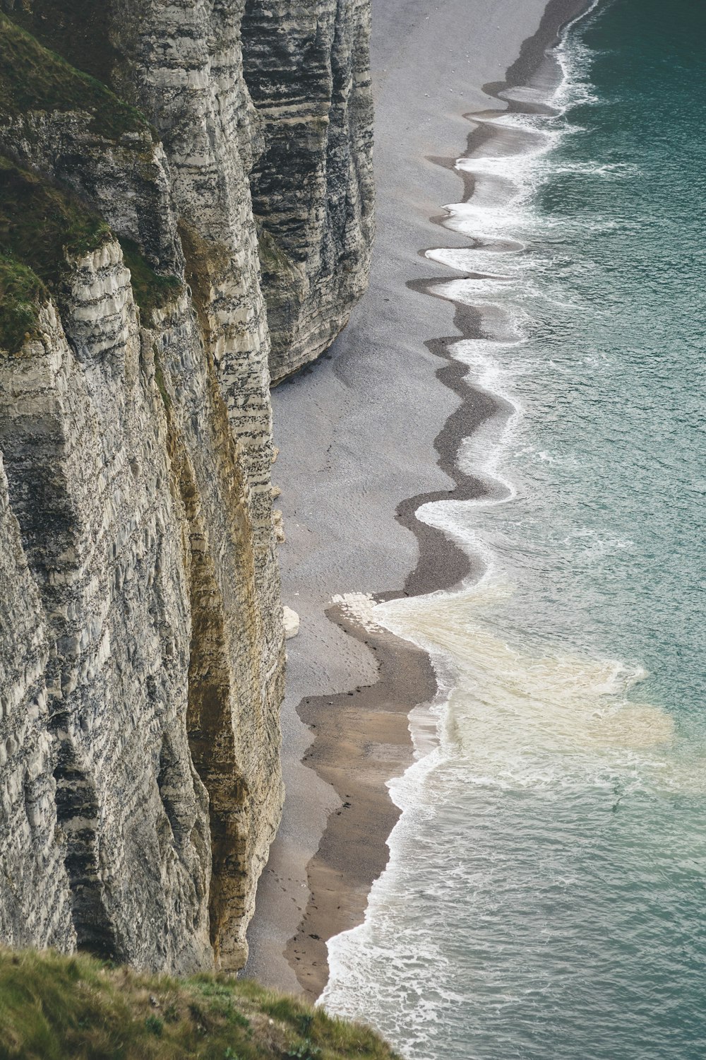 sea waves crushing to shore near rock formation