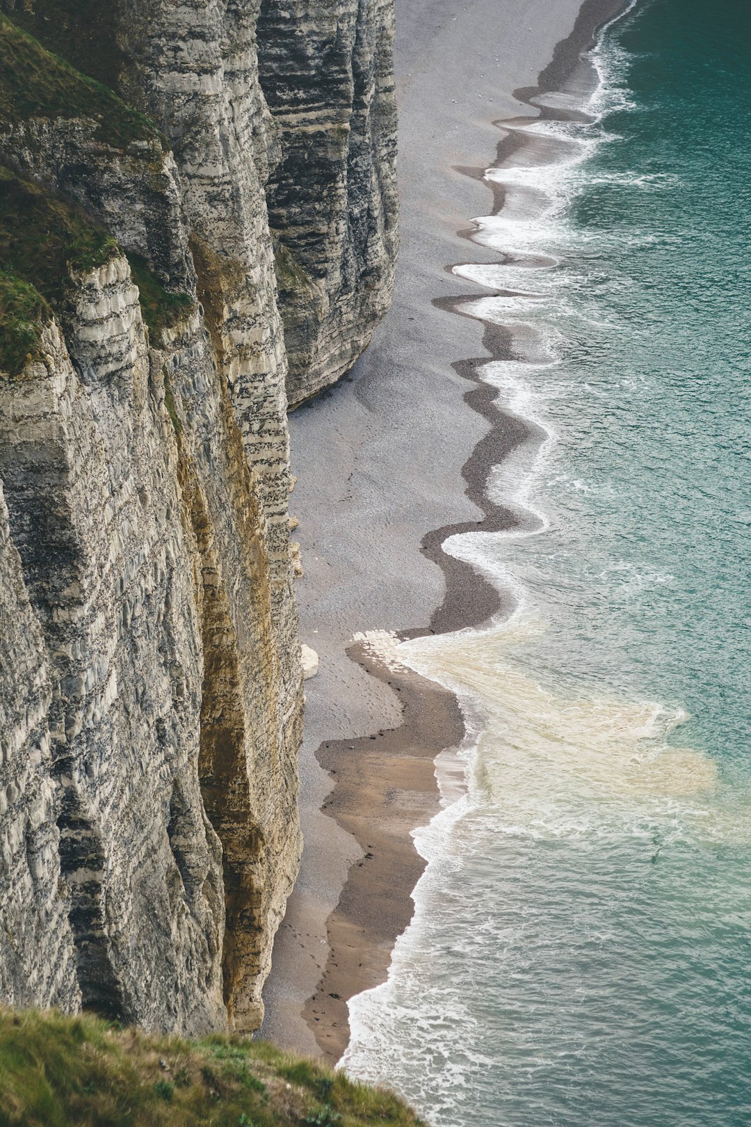 sea waves crushing to shore near rock formation