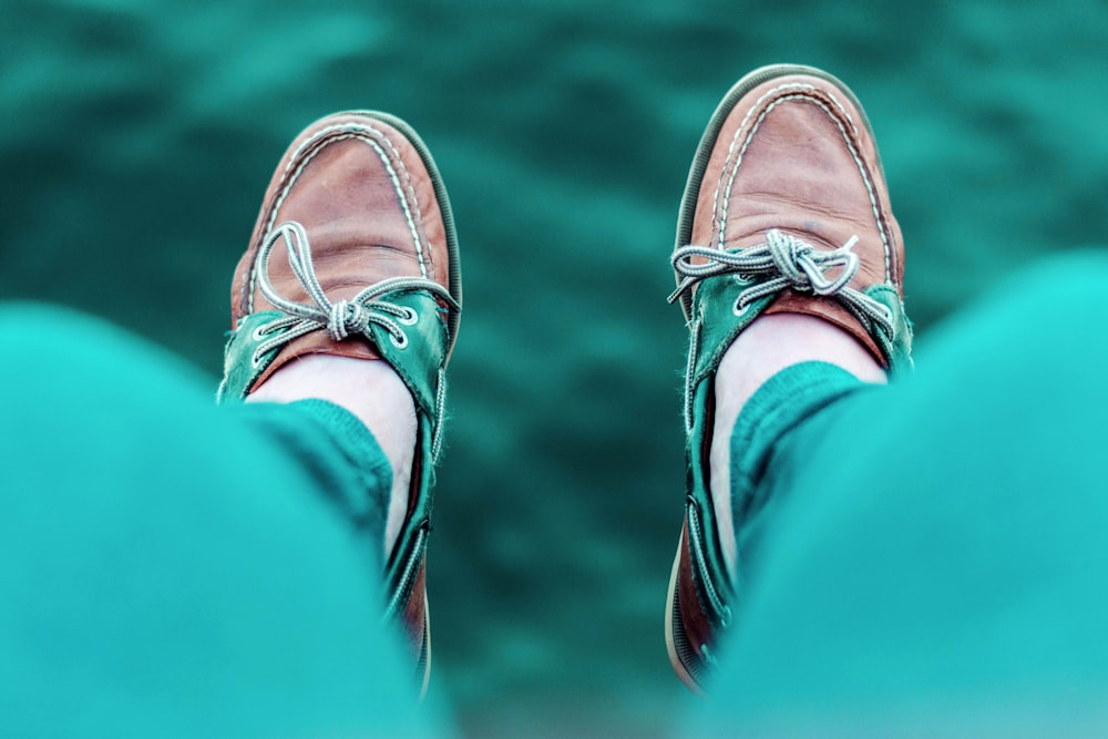 person wearing brown boat shoes