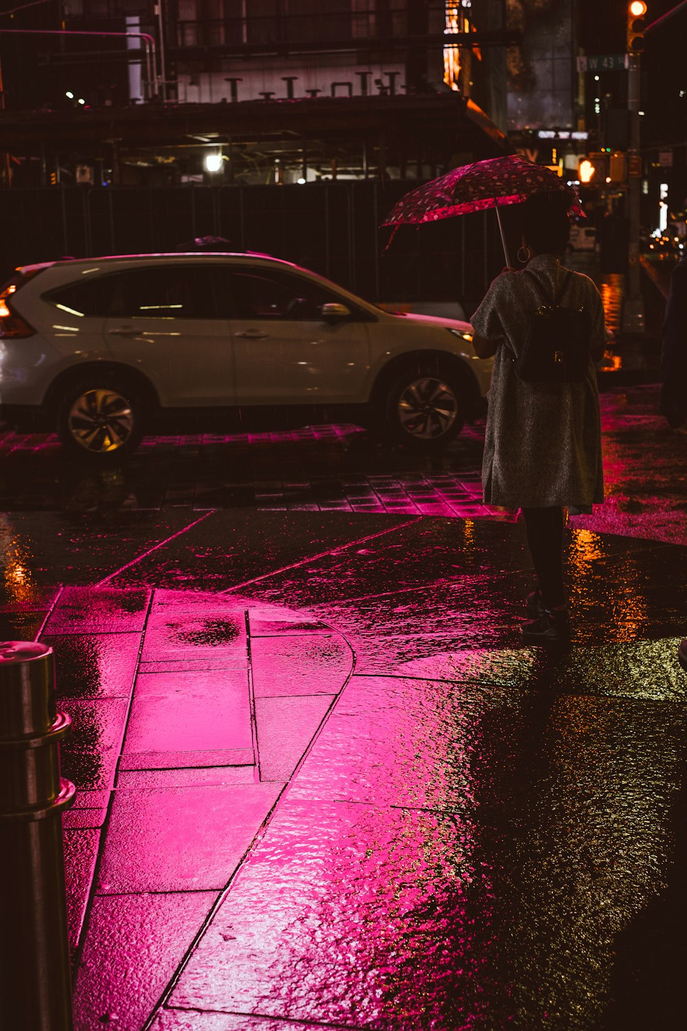 person holding umbrella while walking