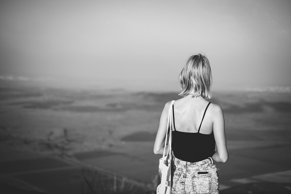 grayscale photography of woman standing