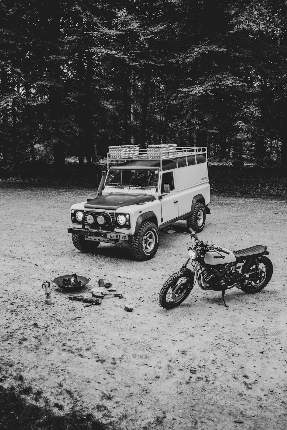 fotografia in scala di grigi di SUV e motocicletta