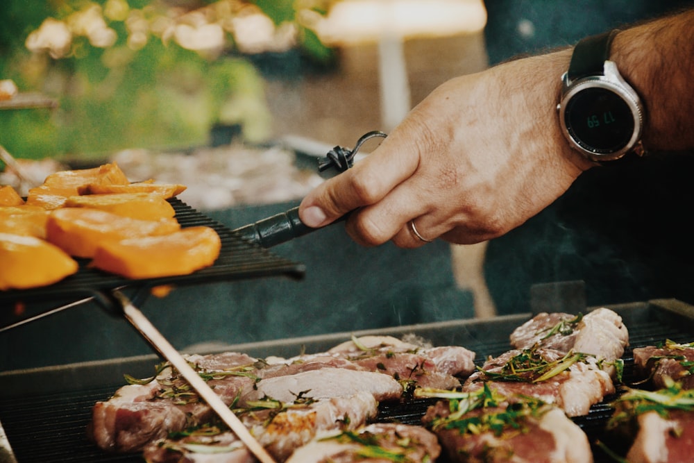 person grilling meat