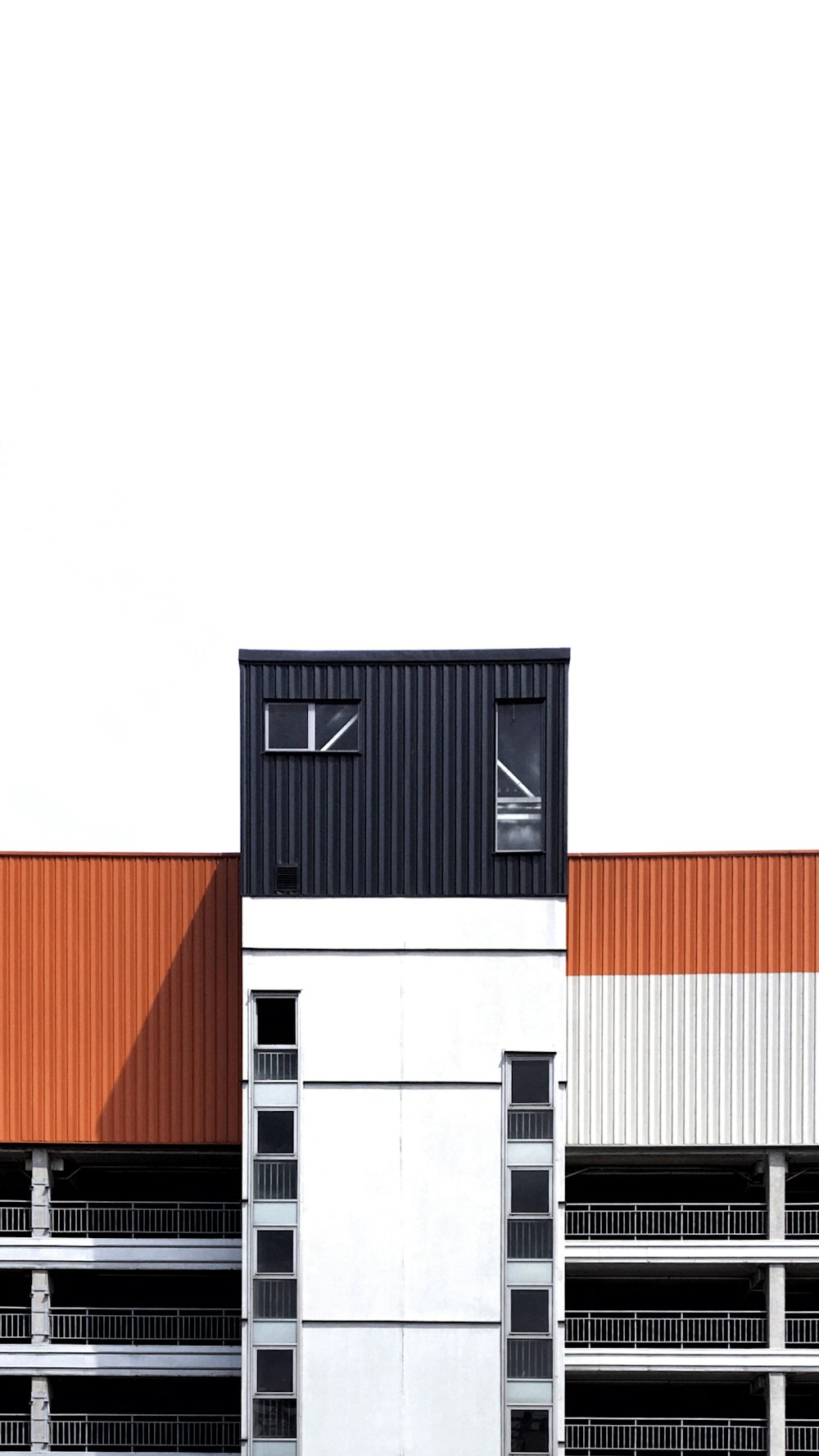 white and beige concrete building on white sky during daytime