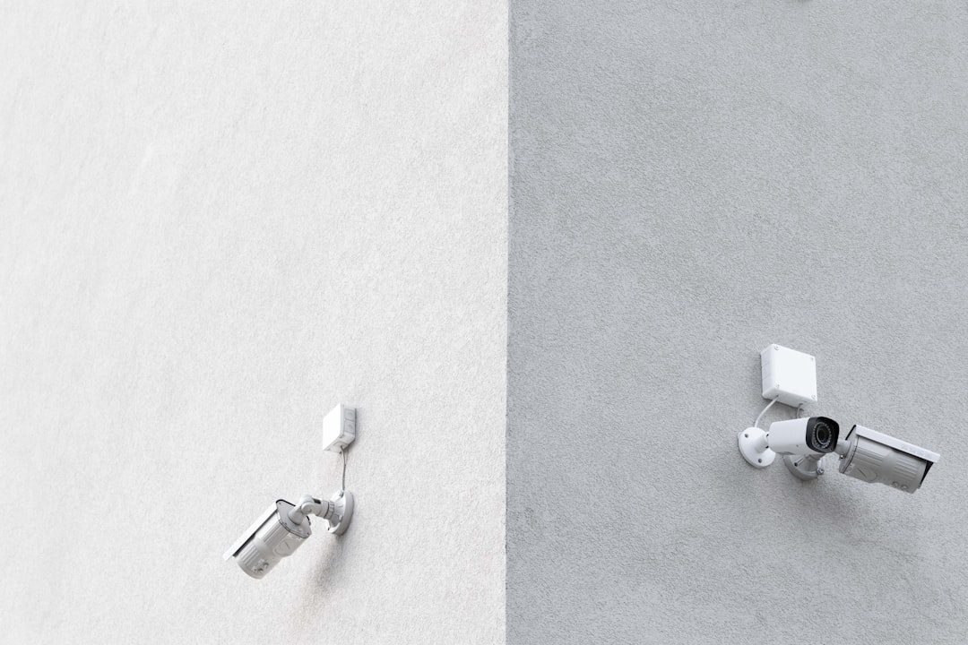 three white CCTV cameras mounted on wall, I liked the simplicity of the view. There were two or even three cameras on ea