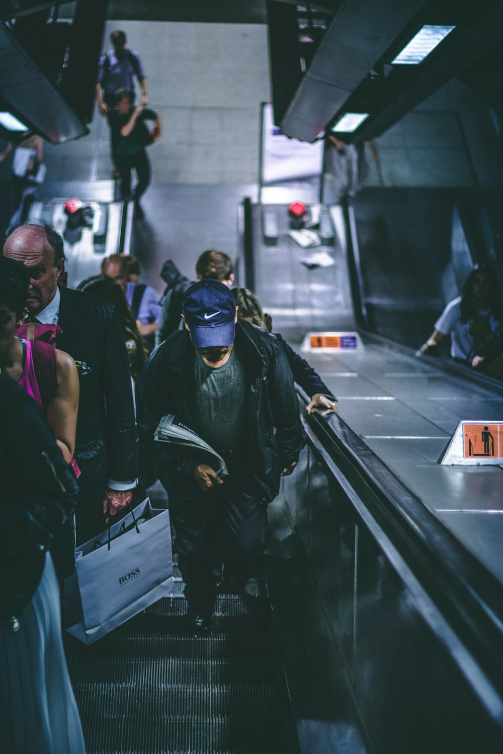 people riding escalator