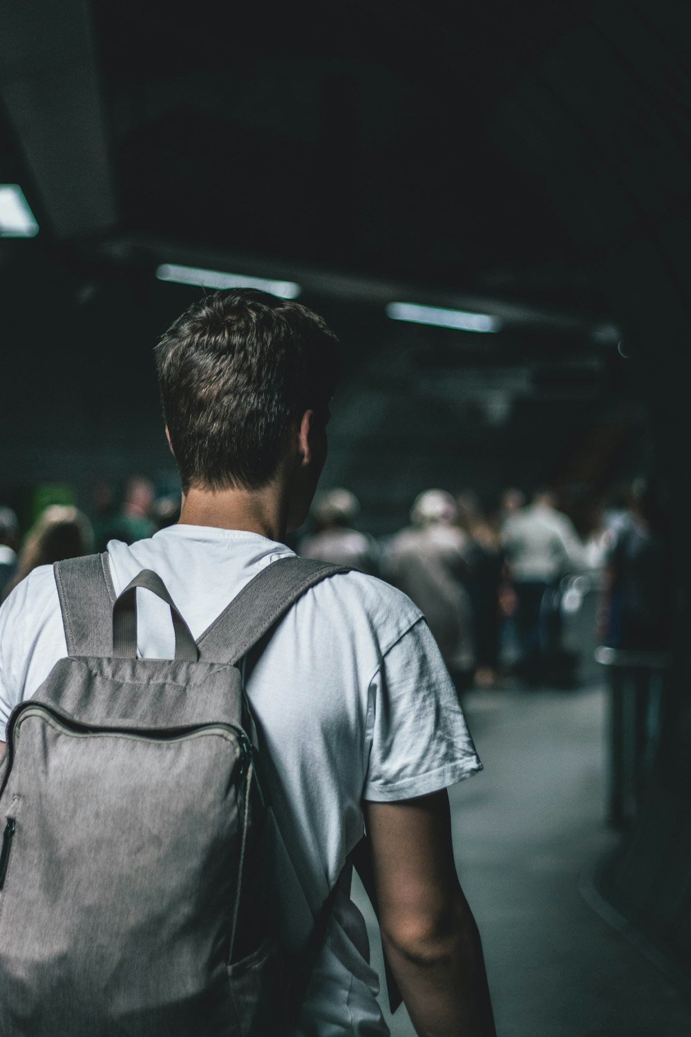 man carrying backpack standing