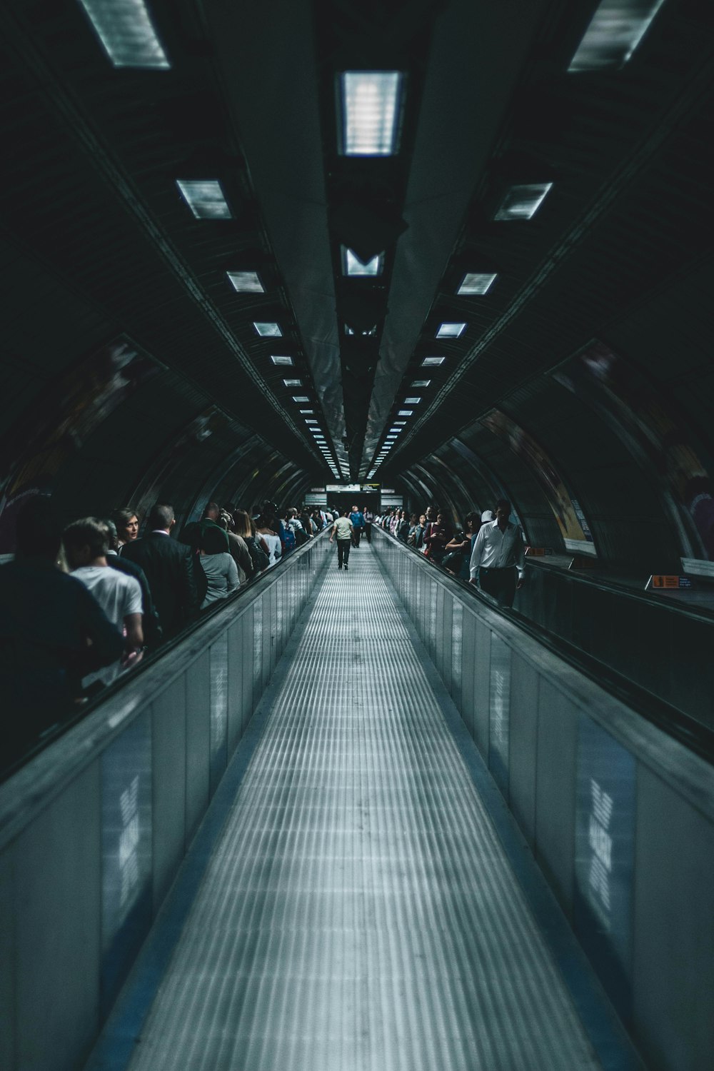 person waking on escalator