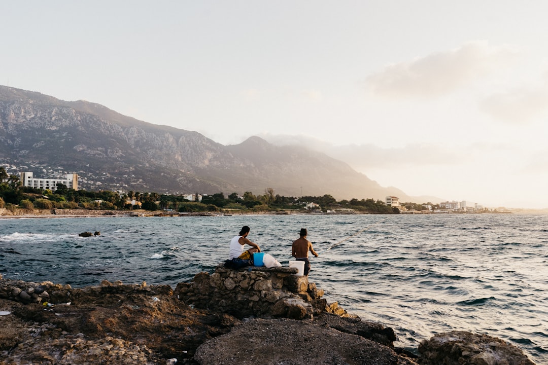 two men near sea at daytime