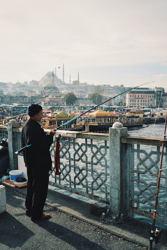man fishing using black and blue fishing rod in Istanbul Turkey