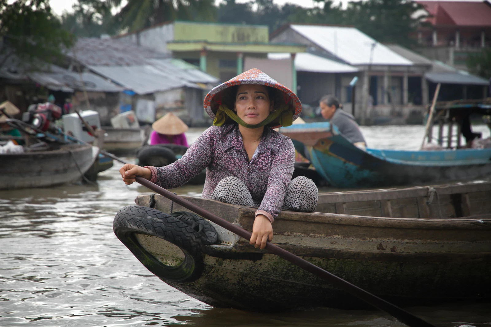A wooden cargo boat on a Mekong Delta river channel