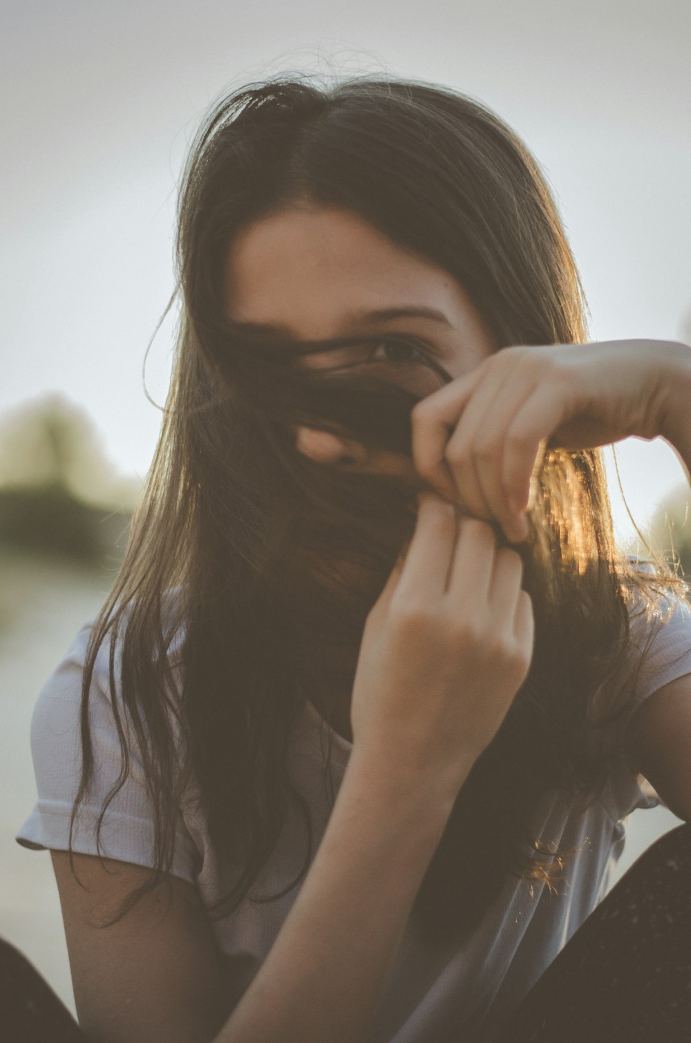 man covering her face with her hair