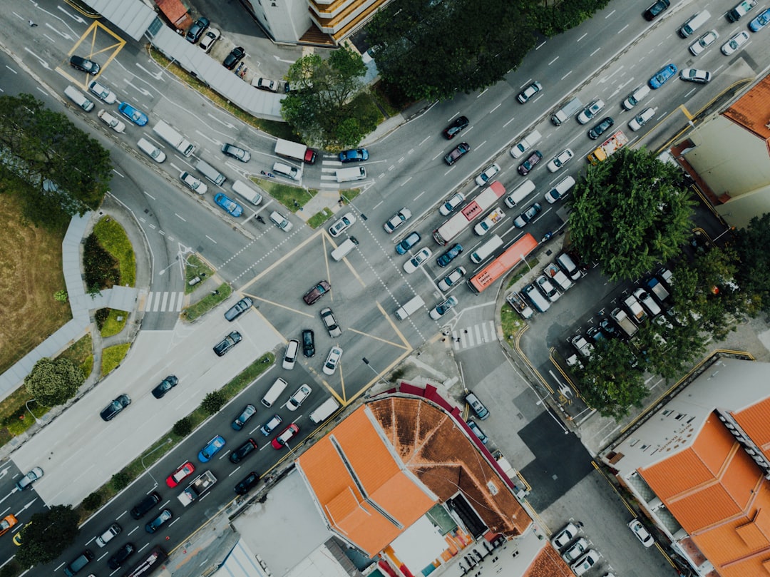 aerial view of cars passing on road near buildings