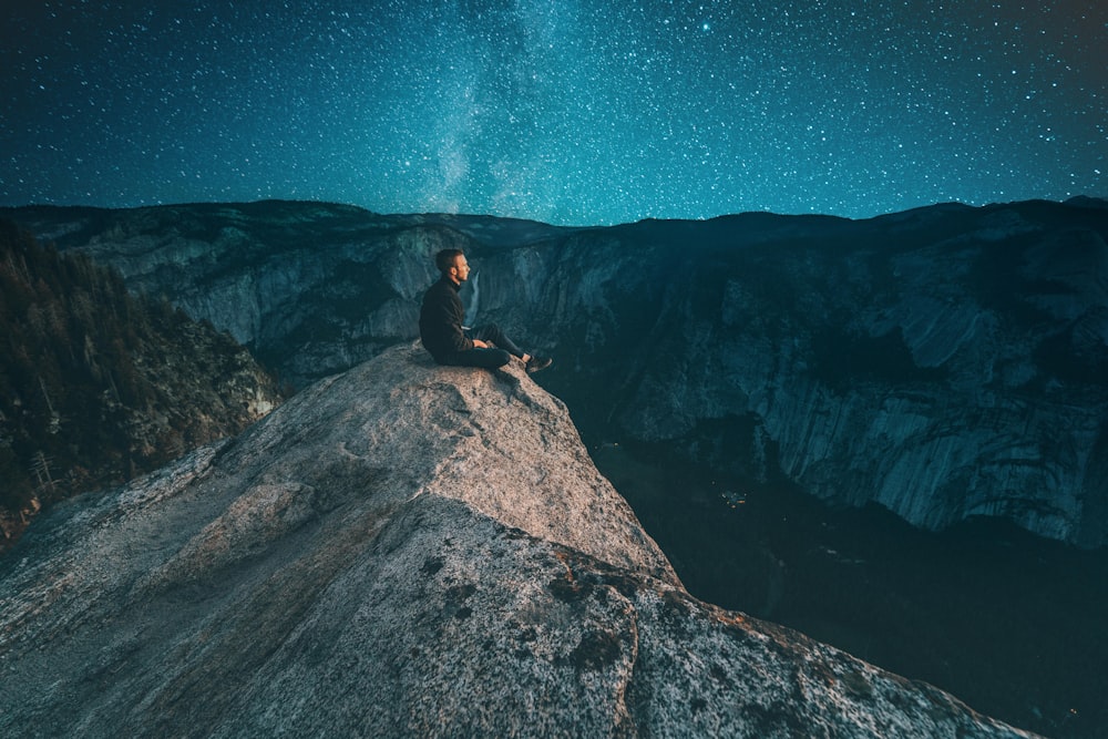 person sitting on mountain