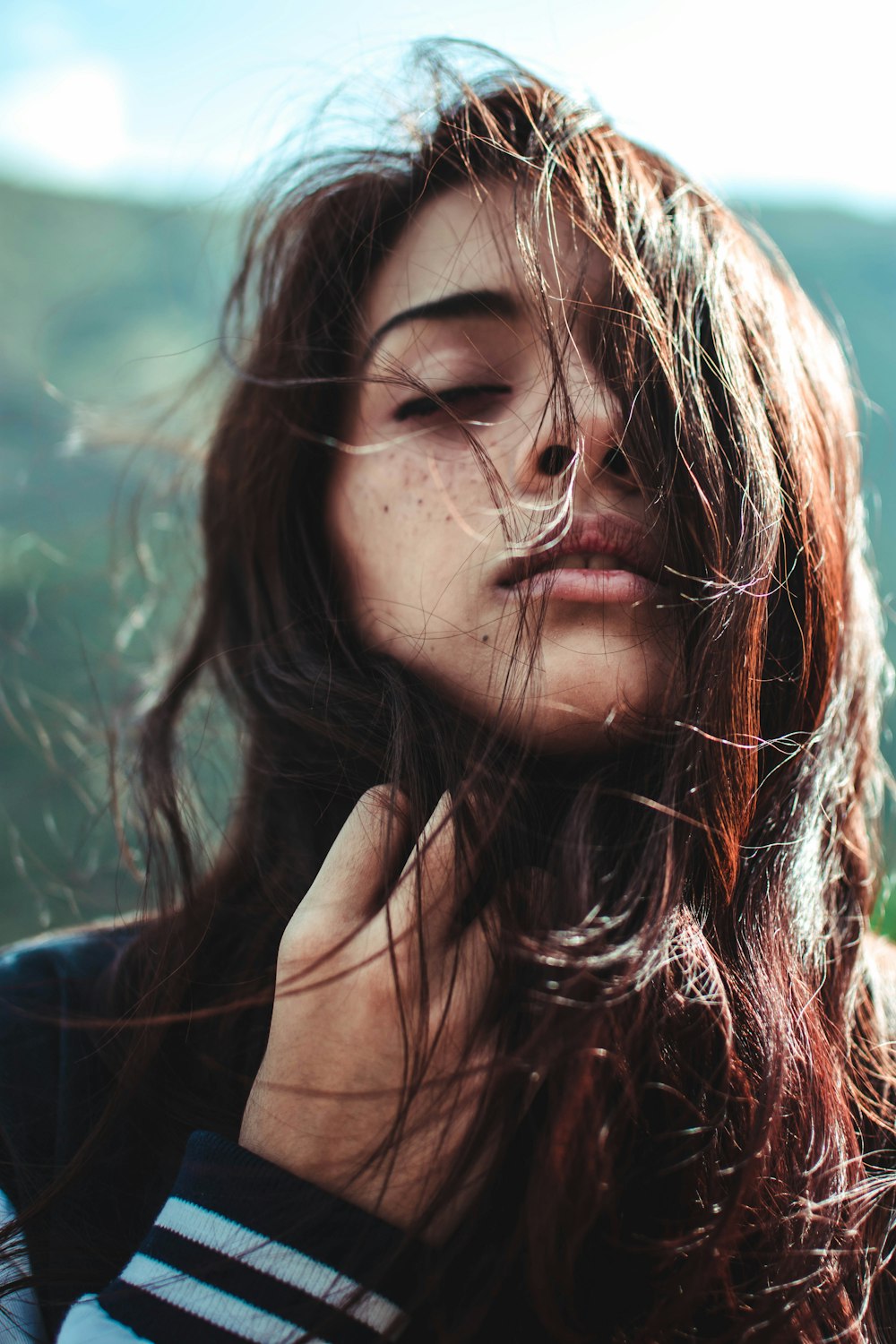 woman in black top holding her hair