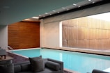 two gray sofas beside pool in room