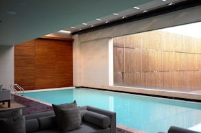 two gray sofas beside pool in room