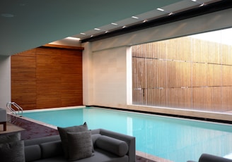 two gray sofas beside pool in room