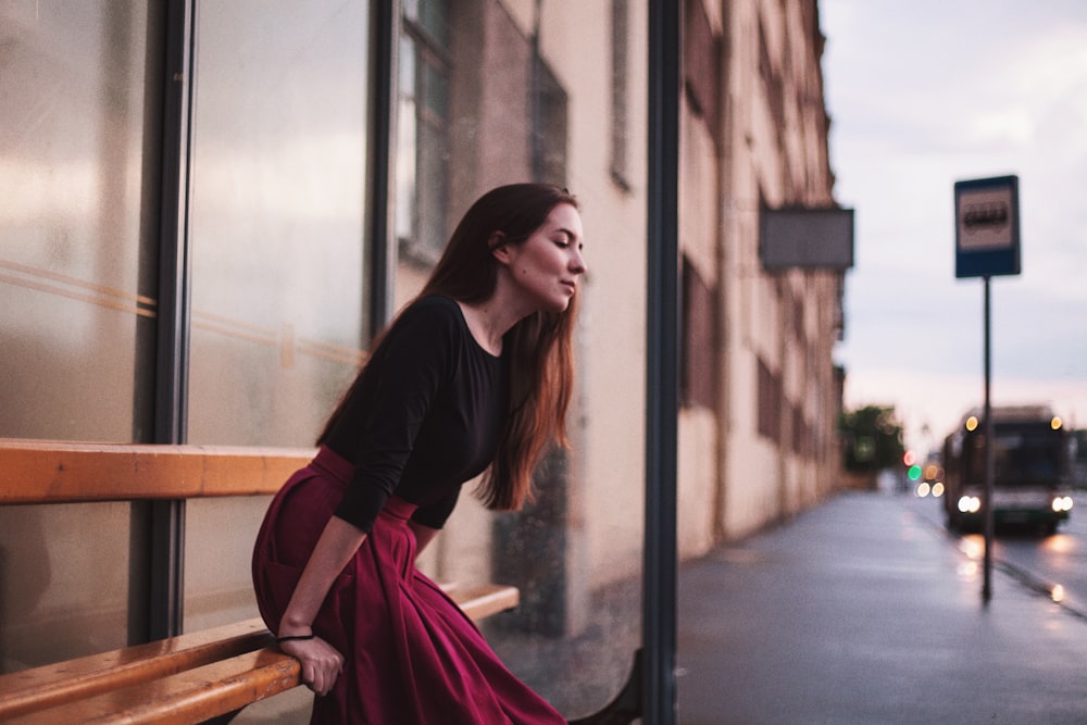 photography woman sitting on bench near outdoor post lamp