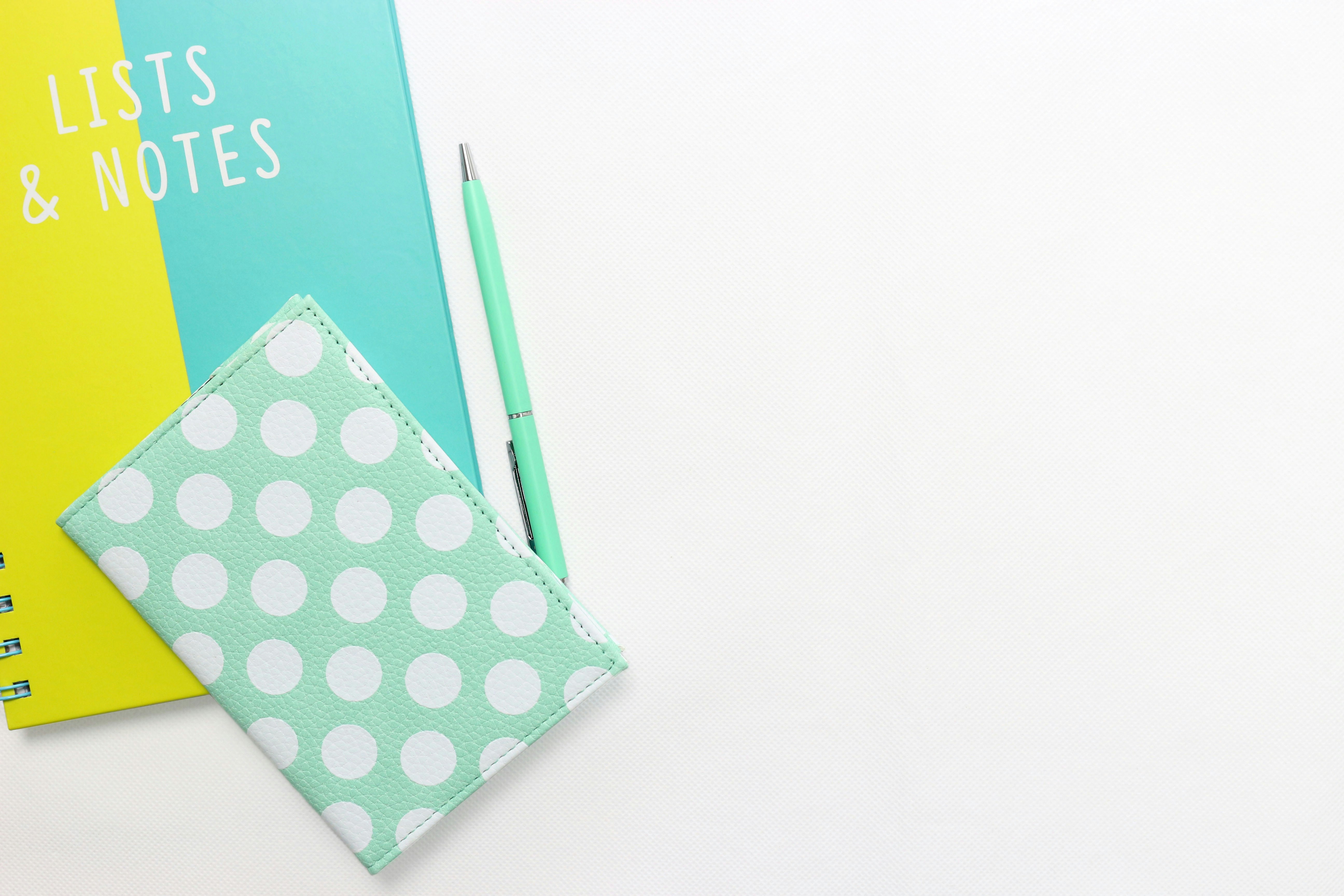 teal and white polka-dot wallet on table
