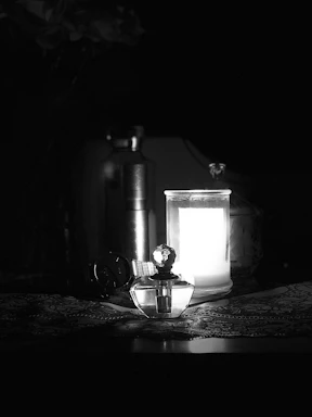 A cozy, elegant corner with scented candles and perfume bottles reflecting soft light.